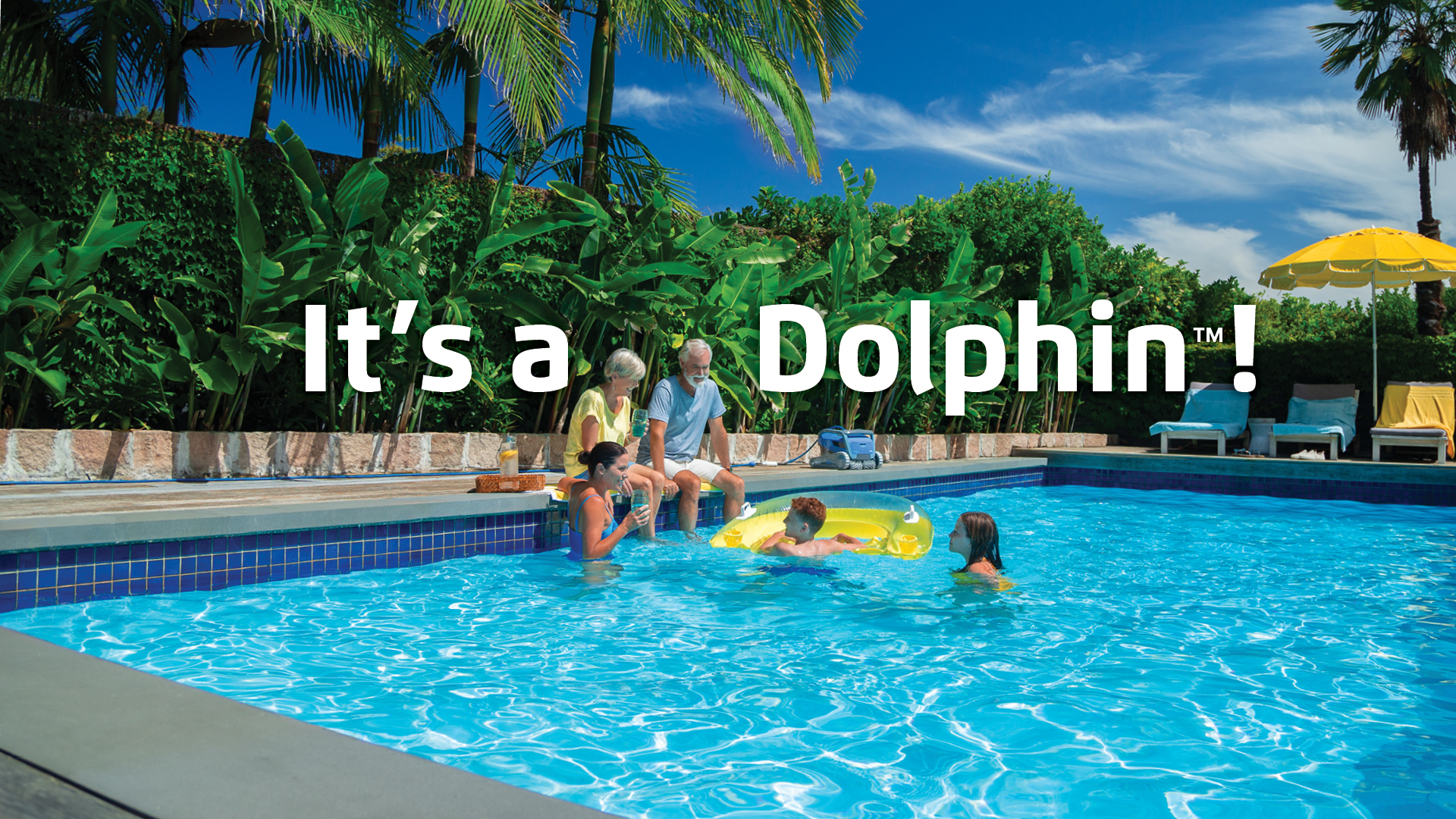 It’s a Dolphin! Pool Cleaning Made Easy – family relaxing in a pool while a Dolphin robotic cleaner works